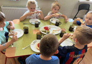 Dzieci jedzą drugie śniadanie.