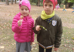 Dzieci trzymają kolorowe liście.