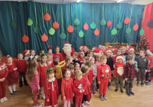 Dzieci z oddziału przedszkolnego spiewają piosenkę Mikołajowi.