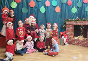 Dzieci z grupy "Jeżyki" pozują do zdjęcia z Mikołajem.