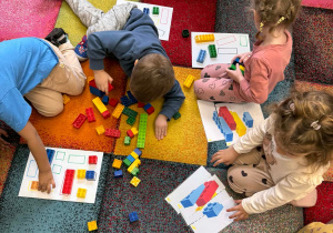 Dzieci rozwiązują zadania z wykorzystaniem klocków Lego