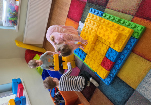 Laura, Mikołaj i Stefan budują piramidę z klocków "Maxi".