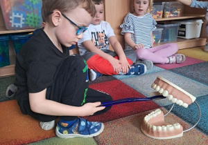 Chłopiec prezentuje jak myć zęby.