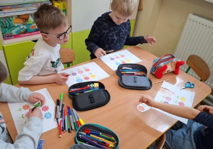 Dzieci pracują przy stole.