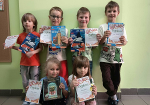 dzieci pozują do zdjęcia trzymając dyplomy